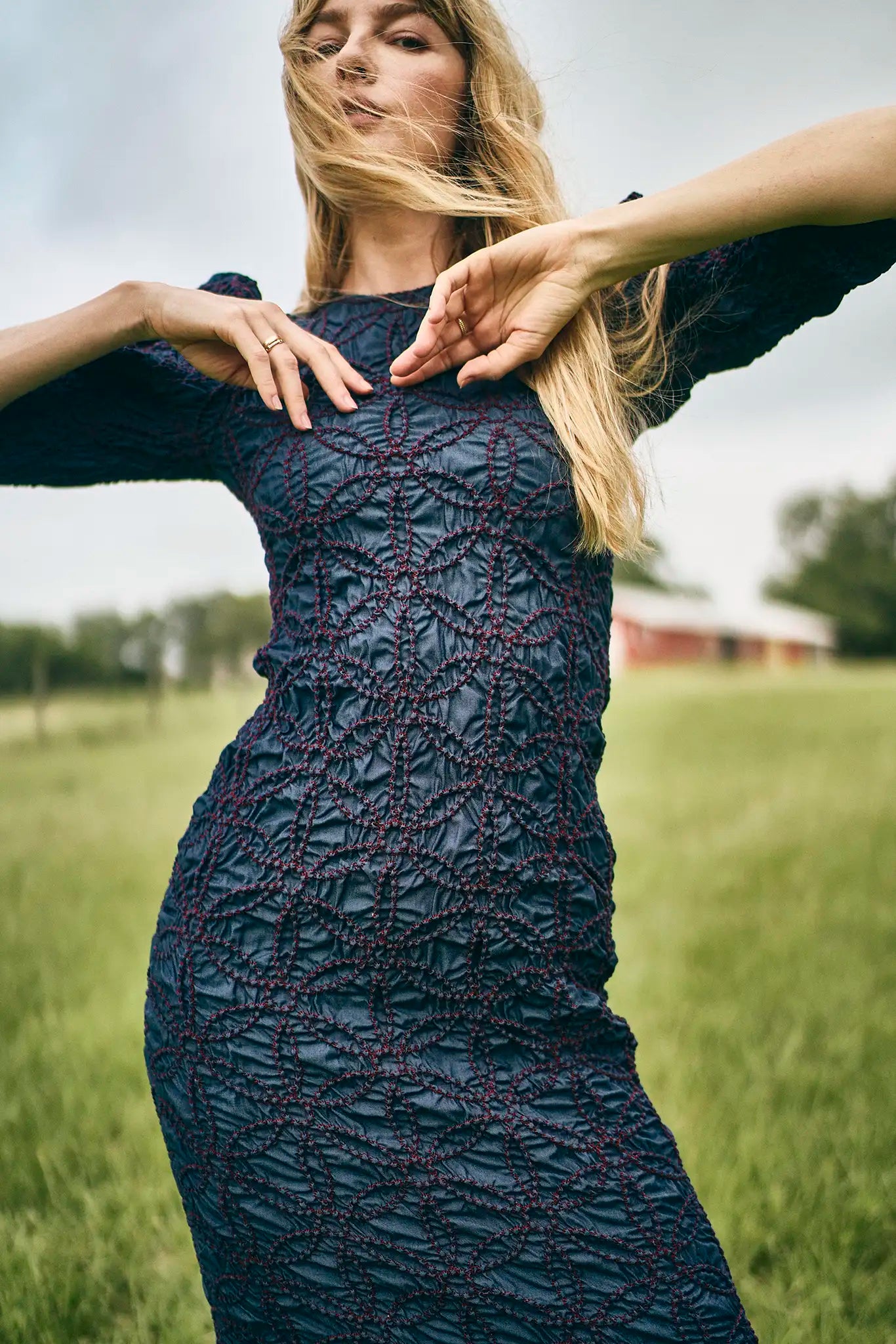 The Blythe Dress is midi body con dress with a crew neckline and oversized ruched long sleeves.