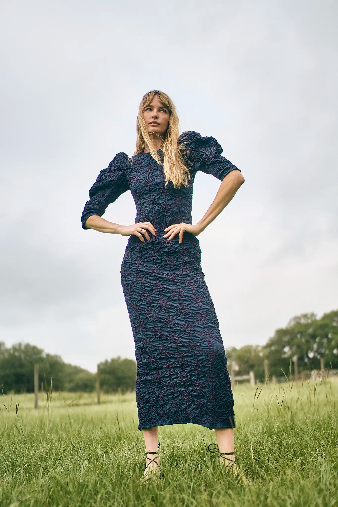 The Blythe Dress is midi body con dress with a crew neckline and oversized ruched long sleeves.