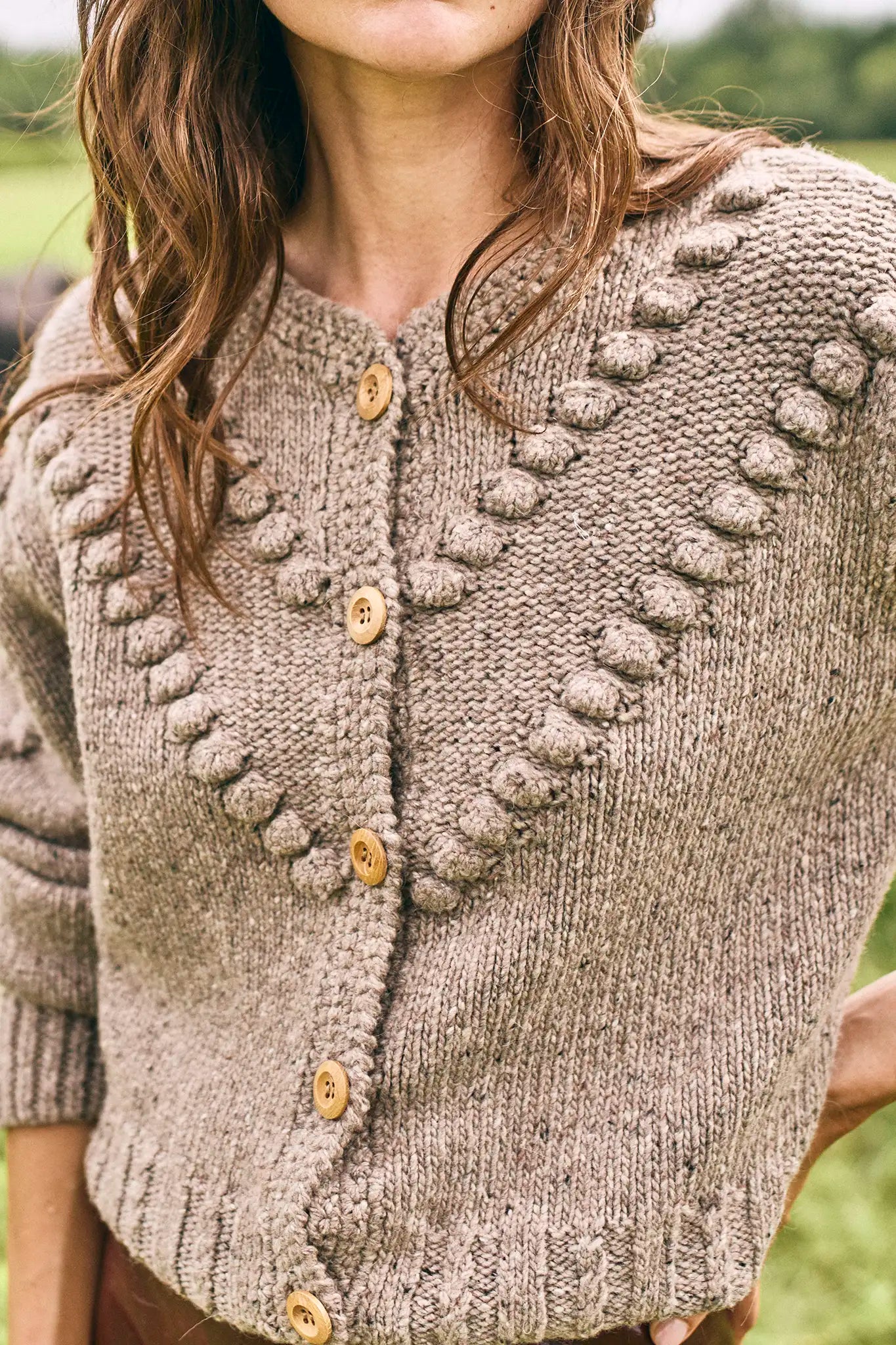 The Bobble Sweater is a crew neck style with a button-front, long sleeves and an oversized fit.