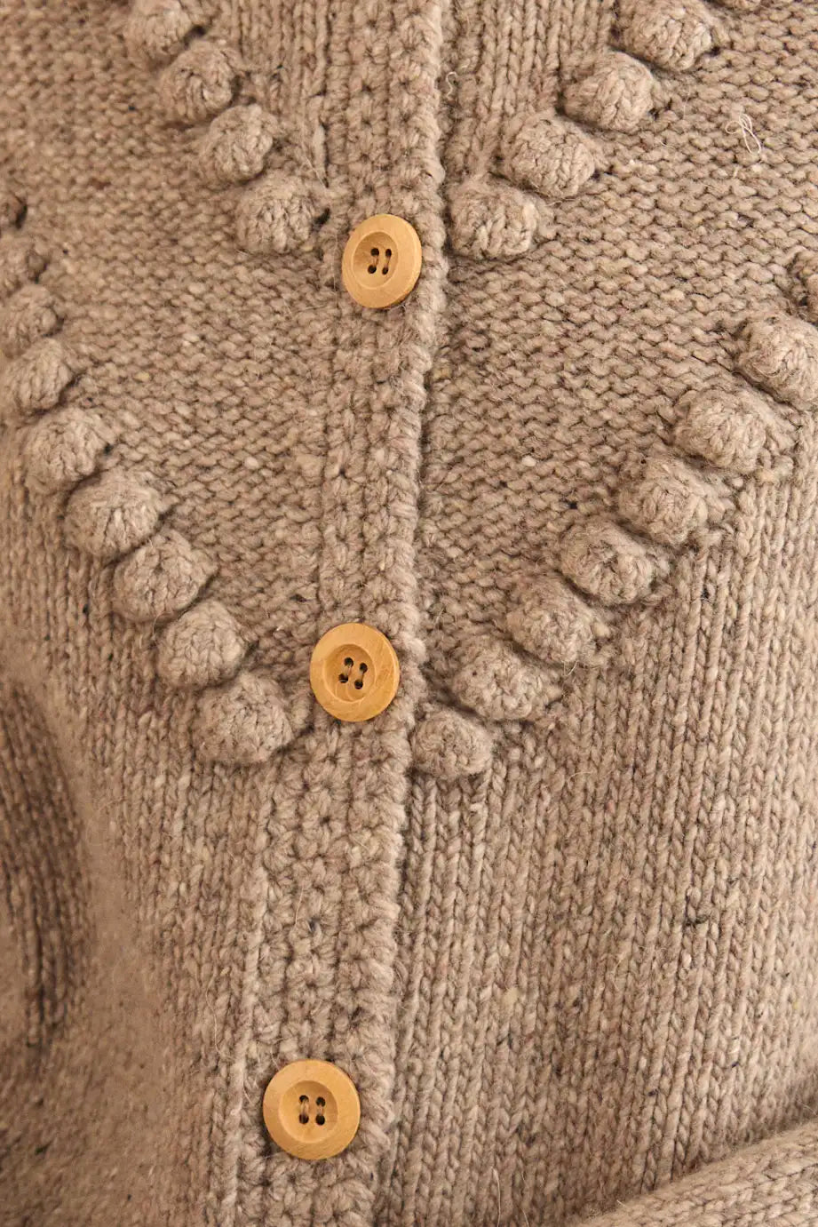 The Bobble Sweater is a crew neck style with a button-front, long sleeves and an oversized fit.