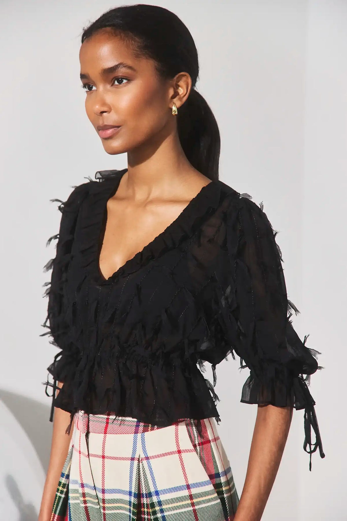 The Bridges Top in Manhattan Chiffon Onyx paired with the Ridley Pant in Kensington Plaid Crimson. 