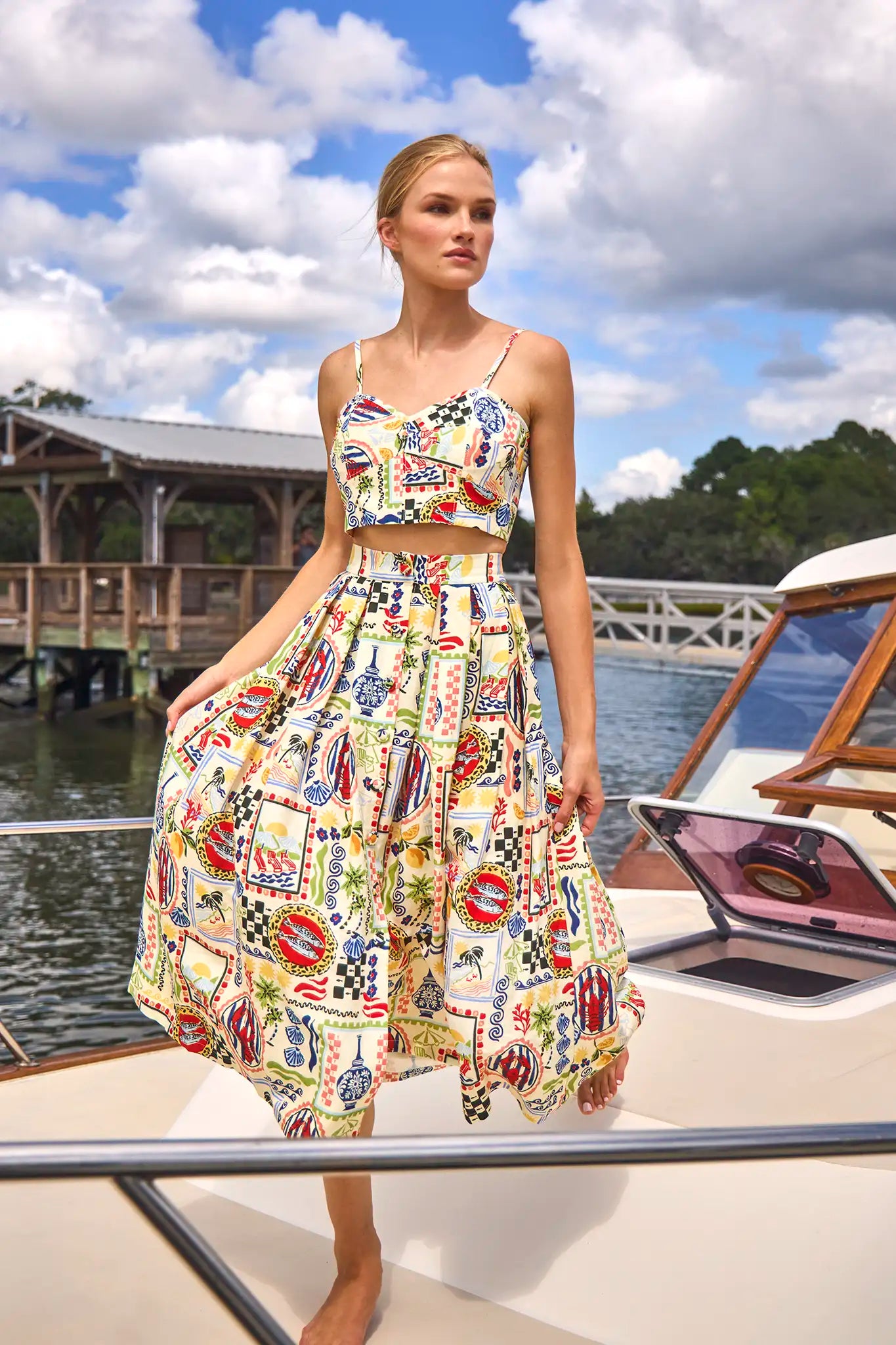 The Eva Skirt in Coastal Conversation paired with matching Brookie Top on model posed on boat