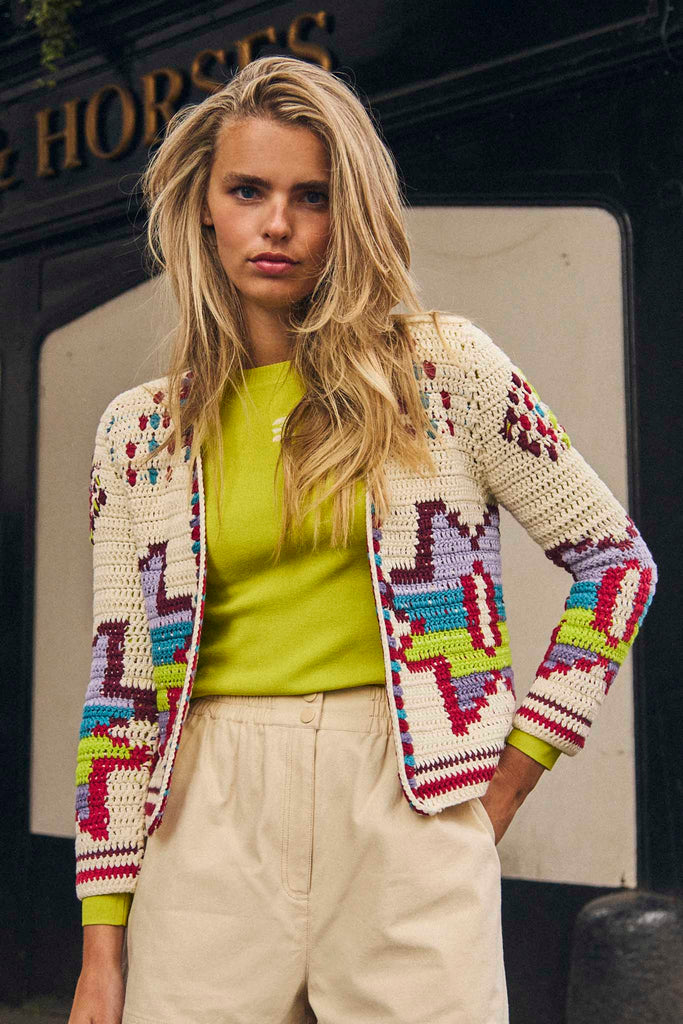 The Callen cardigan is a hand crocheted knit with long sleeves and open placket design.