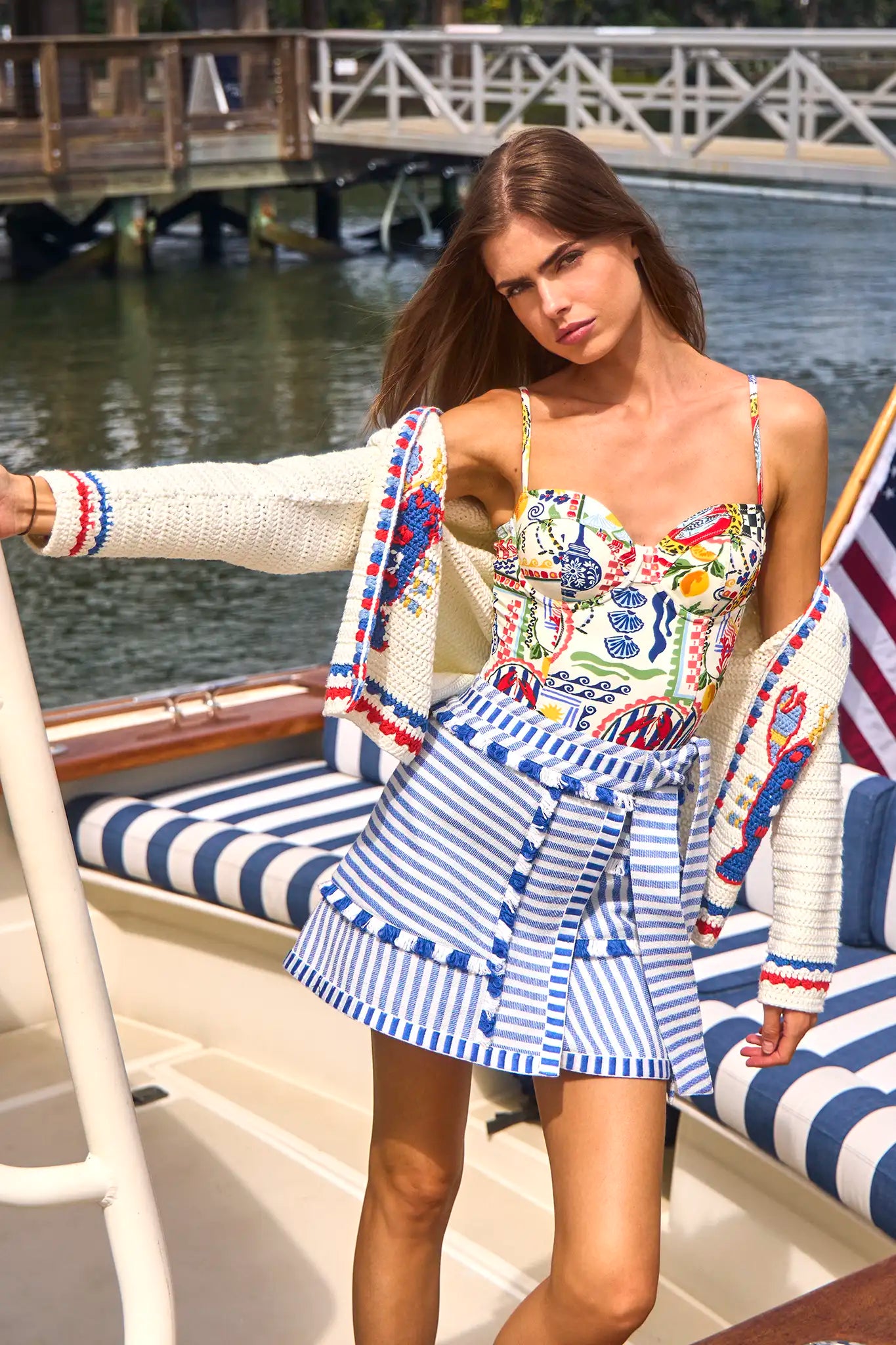 The Callen Cardigan in Lobster Multi paired with bathing suit in coastal conversation and bay skirt.