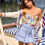 The Callen Cardigan in Lobster Multi paired with bathing suit in coastal conversation and bay skirt.