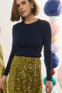 The Callie Sweater in Midnight Blue paired with Lindsey Skirt in Moss Sequin. 