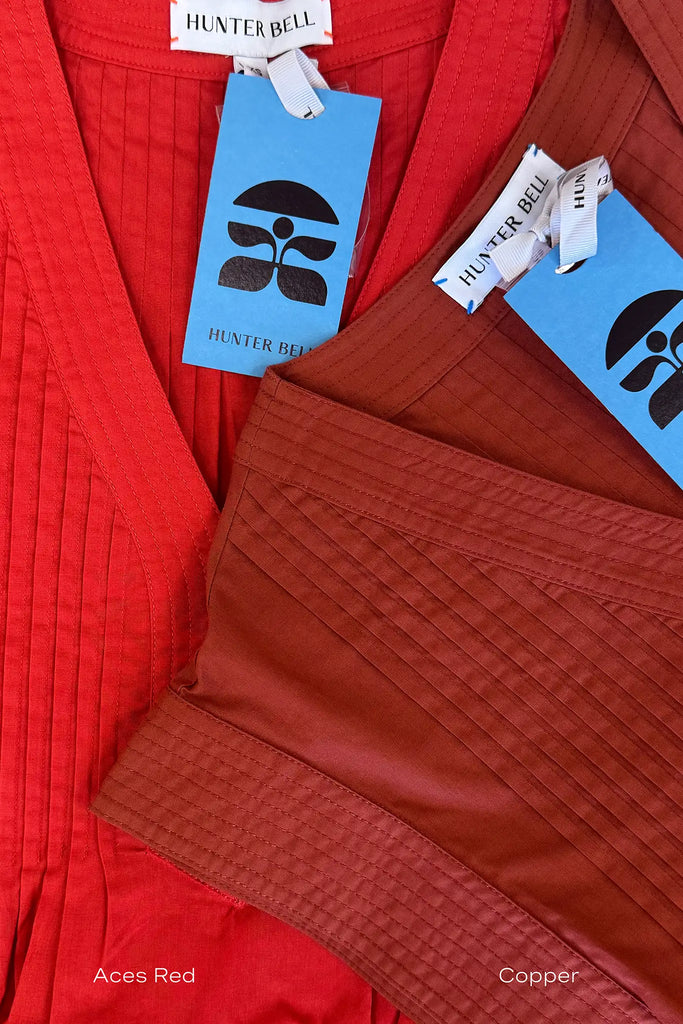 The Parker Dress has a V-neckline, front placket, banded cap sleeves, and side seam pockets.