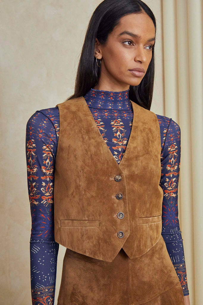Rose is a v-neck suede vest with a darted waist, tailored fit, and front button closure.