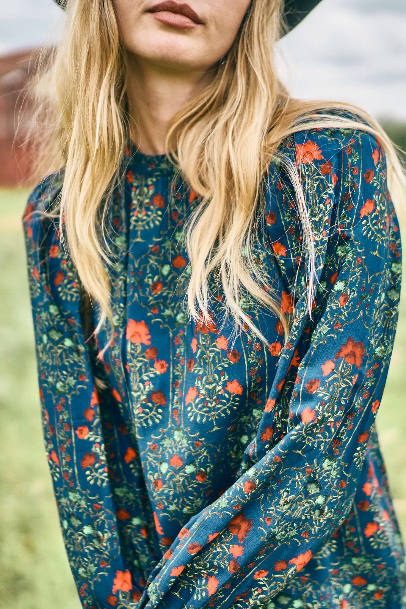 The Crosby Dress has a shirred round neckline, long sleeves, banded cuffs, and straight, silhouette.