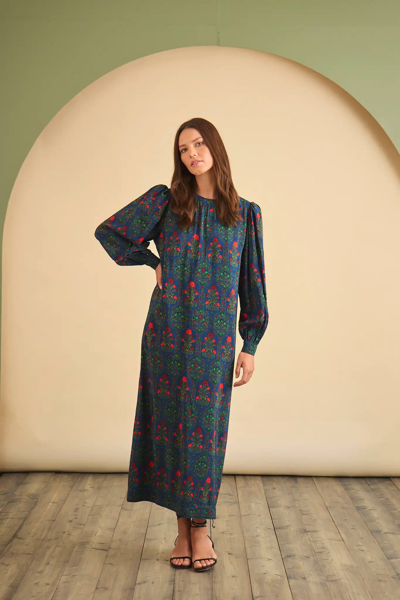 The Crosby Dress has a shirred round neckline, long sleeves, banded cuffs, and straight, silhouette.