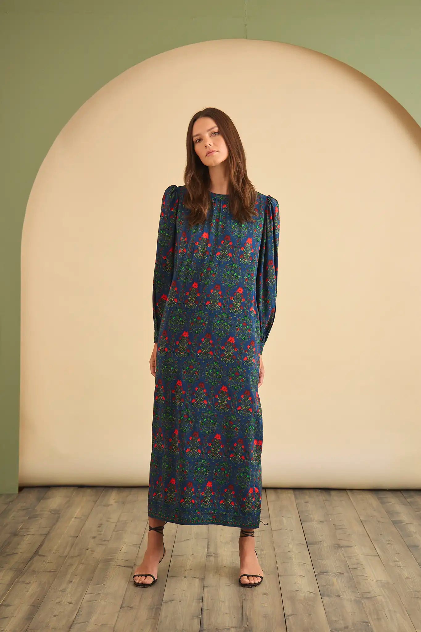 The Crosby Dress has a shirred round neckline, long sleeves, banded cuffs, and straight, silhouette.