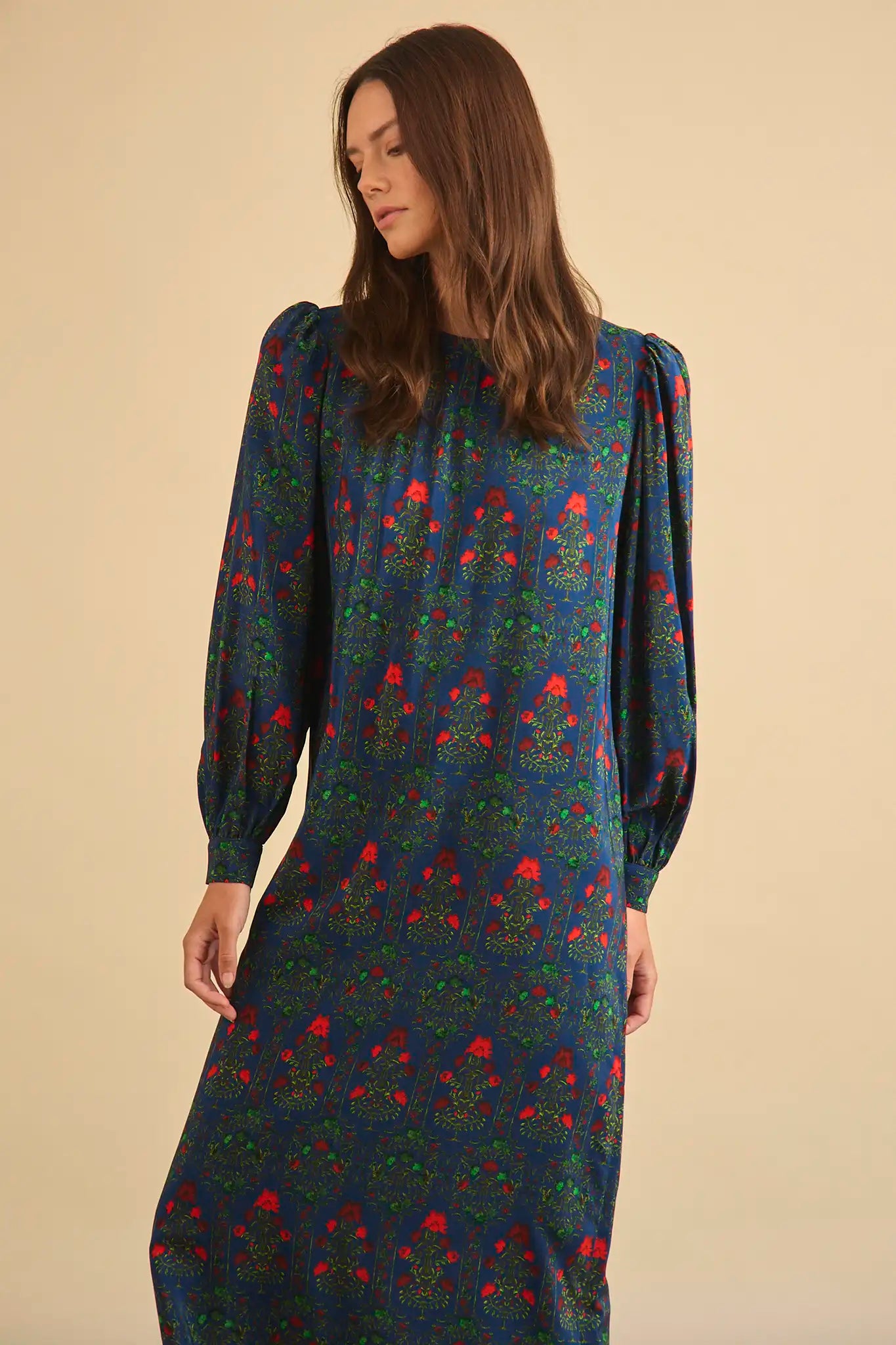 The Crosby Dress has a shirred round neckline, long sleeves, banded cuffs, and straight, silhouette.