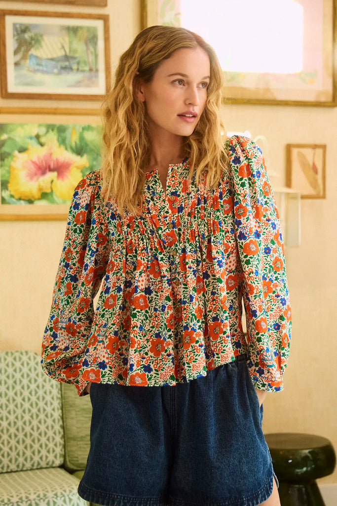 The Daphne Top has pintucking, a button front, a crew neck, and full sleeves with button cuffs.