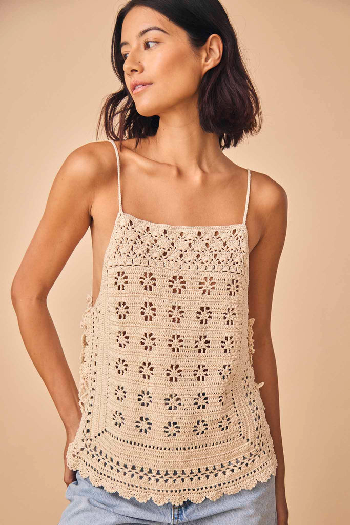 The Debbie crochet top features a cut-away floral with adjustable shoulder strap and side ties.