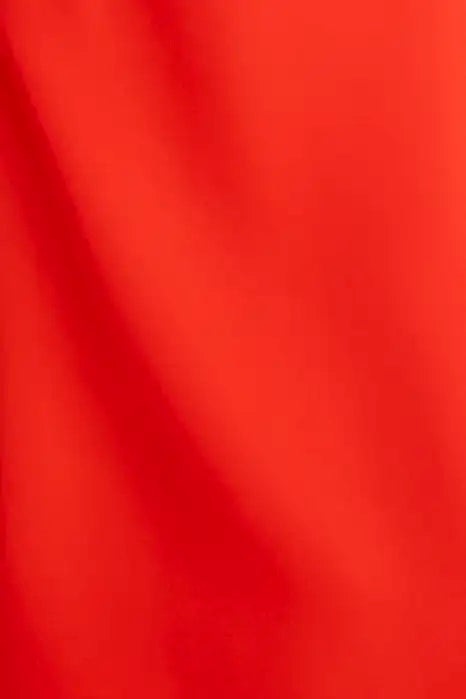 The Delancey Dress is long-sleeve with a shirred round neckline, banded cuffs, and a full skirt.