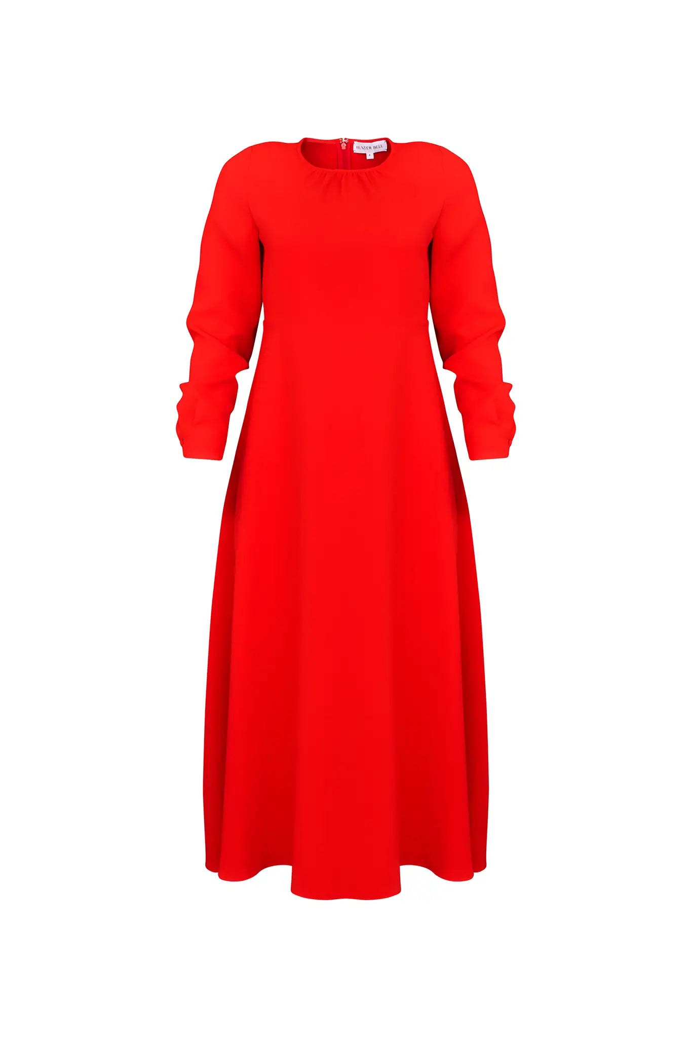 The Delancey Dress is long-sleeve with a shirred round neckline, banded cuffs, and a full skirt.
