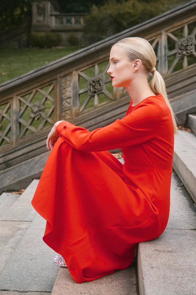 The Delancey Dress is long-sleeve with a shirred round neckline, banded cuffs, and a full skirt.