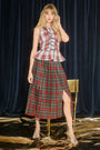 The Dominic Skirt has a banded waist and a straight pleated silhouette finished with front slits. 