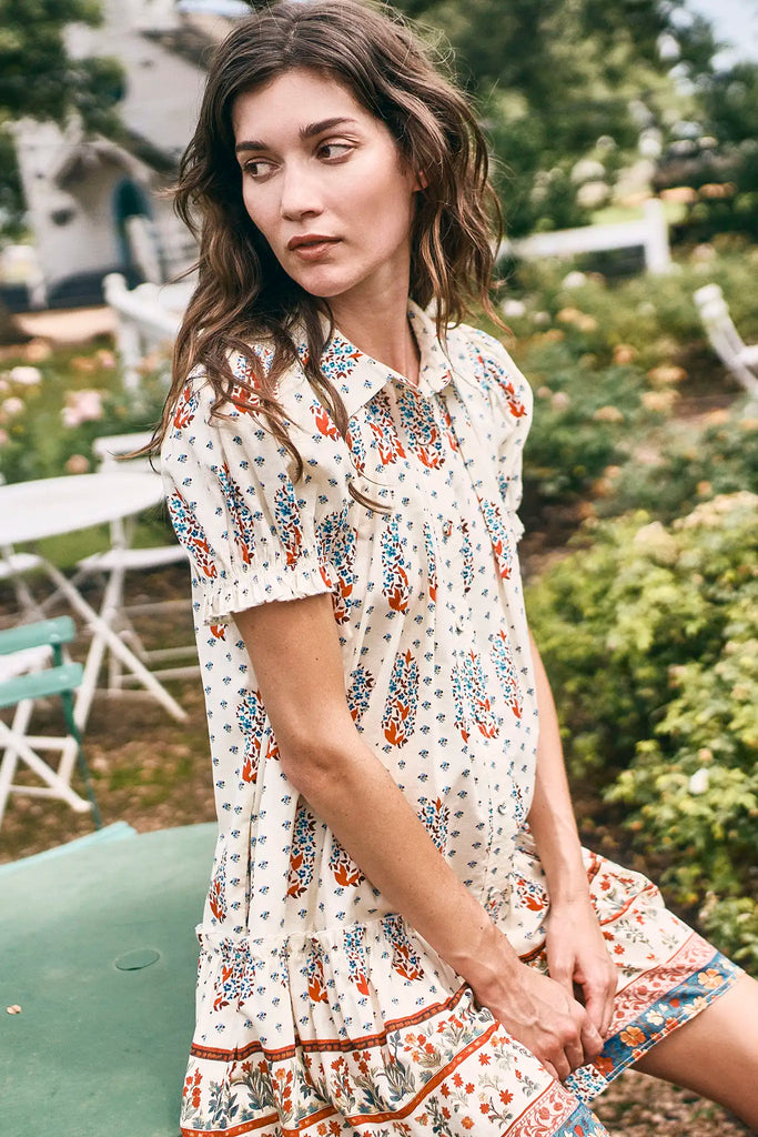 The Drifter Mini has a collared neckline, short puff sleeves, a drop waist and flounce hem.