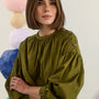 The Eli Top in Pine Grove. Voluminious drop-sleeved top with buttons and crew neckline.