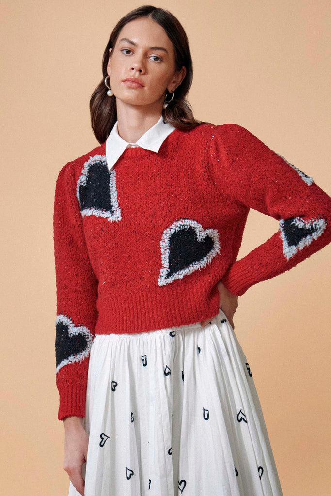 A heart sweater with long tapered puff sleeves and ribbed trim at the neck, cuffs and hem.