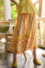 Eva Skirt in Still Life Symphony paired with Everly Top in Lemon Meringue, outside on porch.
