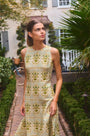 Faith Dress in Green Trellis modeled outside in front of greenery.