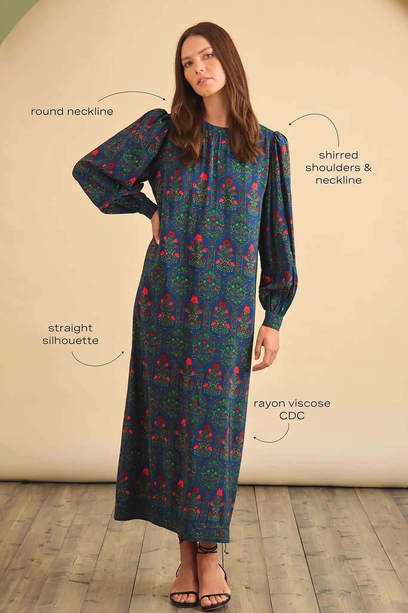 The Crosby Dress has a shirred round neckline, long sleeves, banded cuffs, and straight, silhouette.