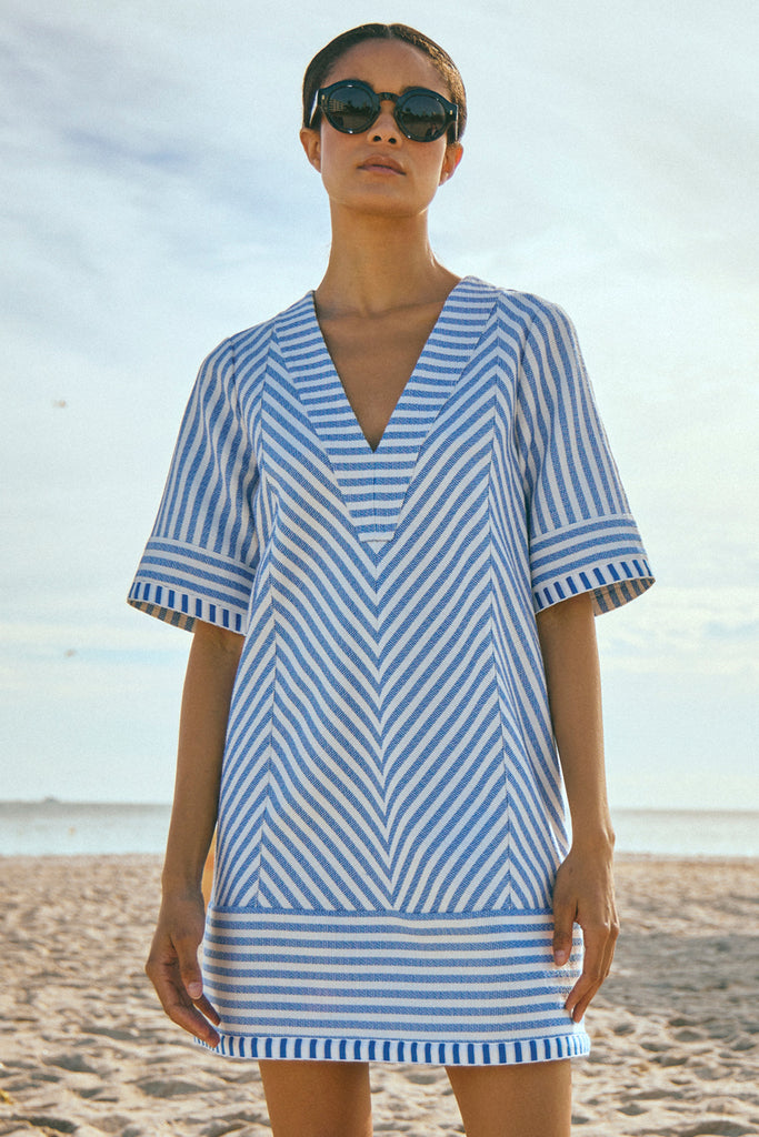 This relaxed shift dress features a contrasting fabric along the v-neckline, hem and sleeve cuffs.