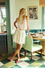 The Corrine Mini Skirt is in Battenberg white lace, clean waistband, and side-seam pockets.