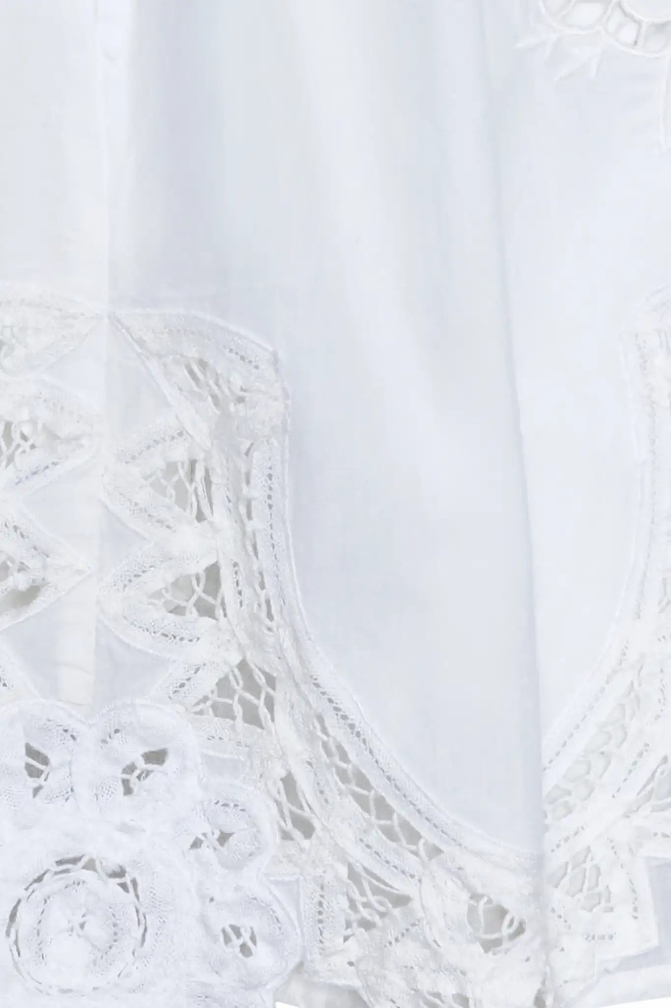 The Corrine Mini Skirt is in Battenberg white lace, clean waistband, and side-seam pockets.