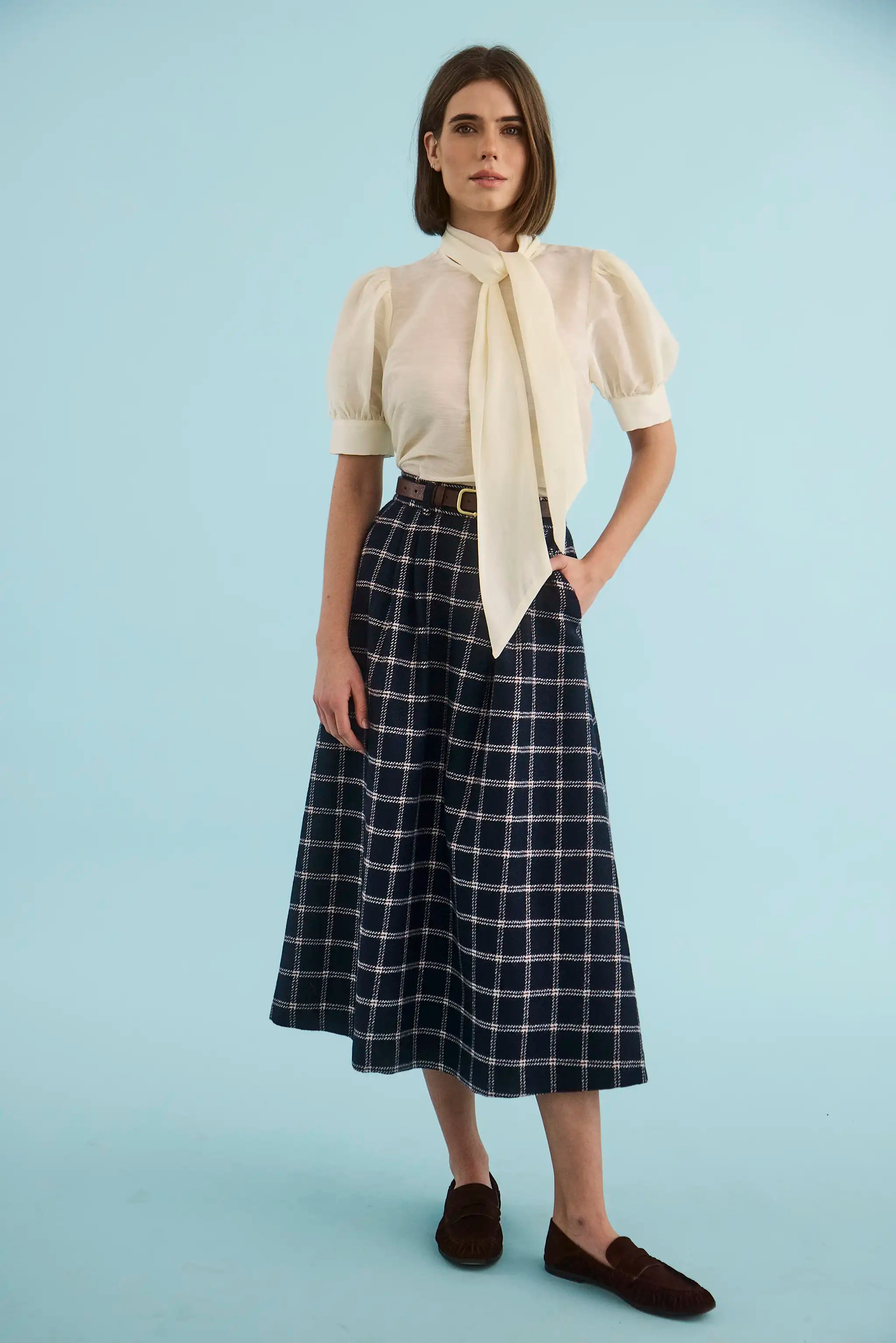 The Gribbon Top in Ivory paired with the Queenby Skirt in St. Andrews Check. 