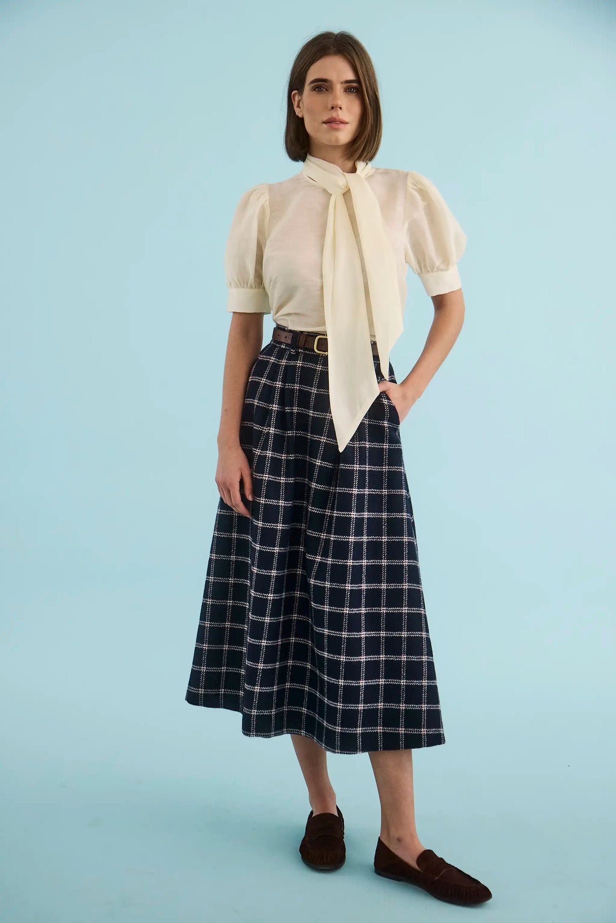 The Gribbon Top in Ivory paired with the Queenby Skirt in St. Andrews Check. 