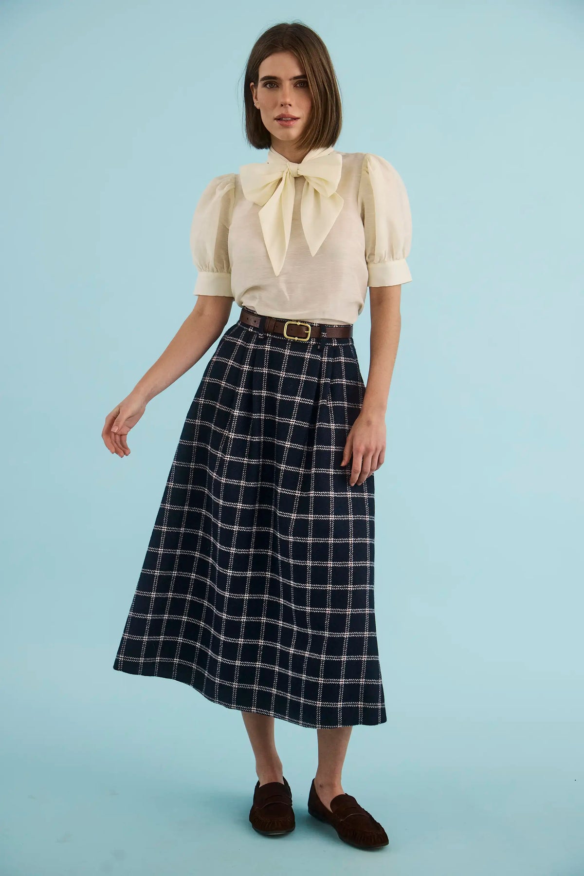 The Queenby Skirt in St. Andrews Check paired with the Gribbon Top in Ivory.