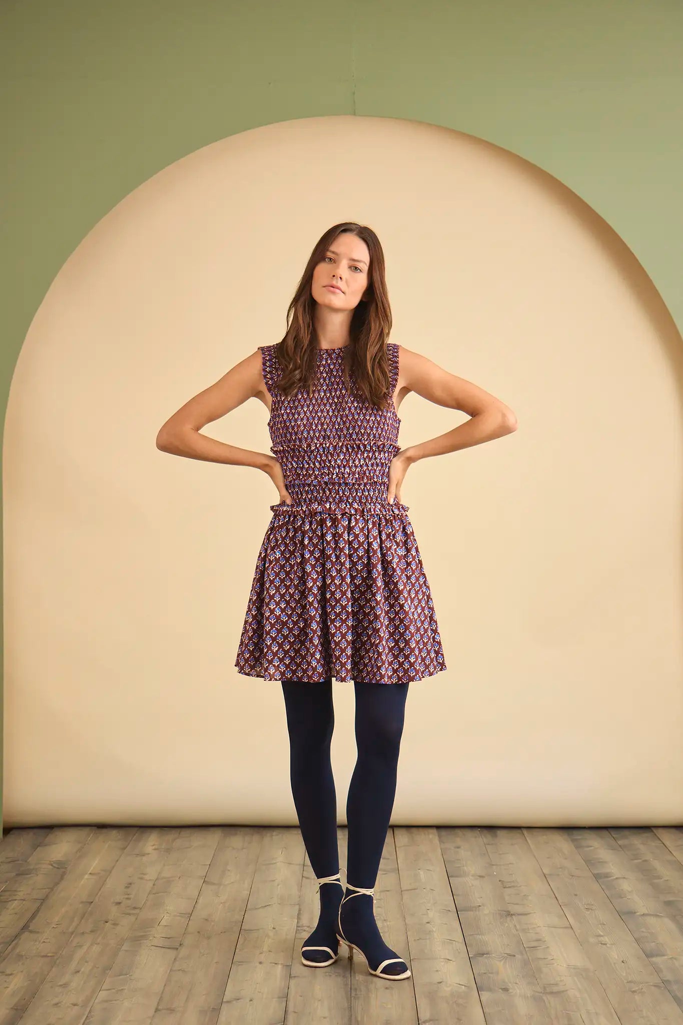 The Gweneth Dress is a sleeveless mini with a round neckline, long smocked bodice and a drop waist.