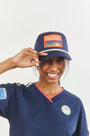 The Hunter Bell x Freya Trucker Hat in Navy paired with navy soccer jersey.