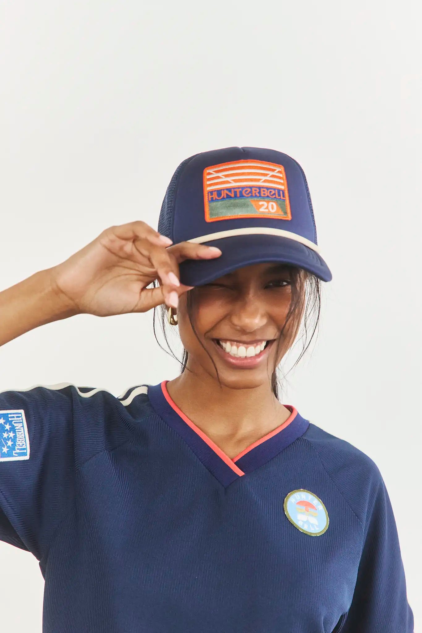 The Hunter Bell x Freya Trucker Hat in Navy paired with navy soccer jersey.