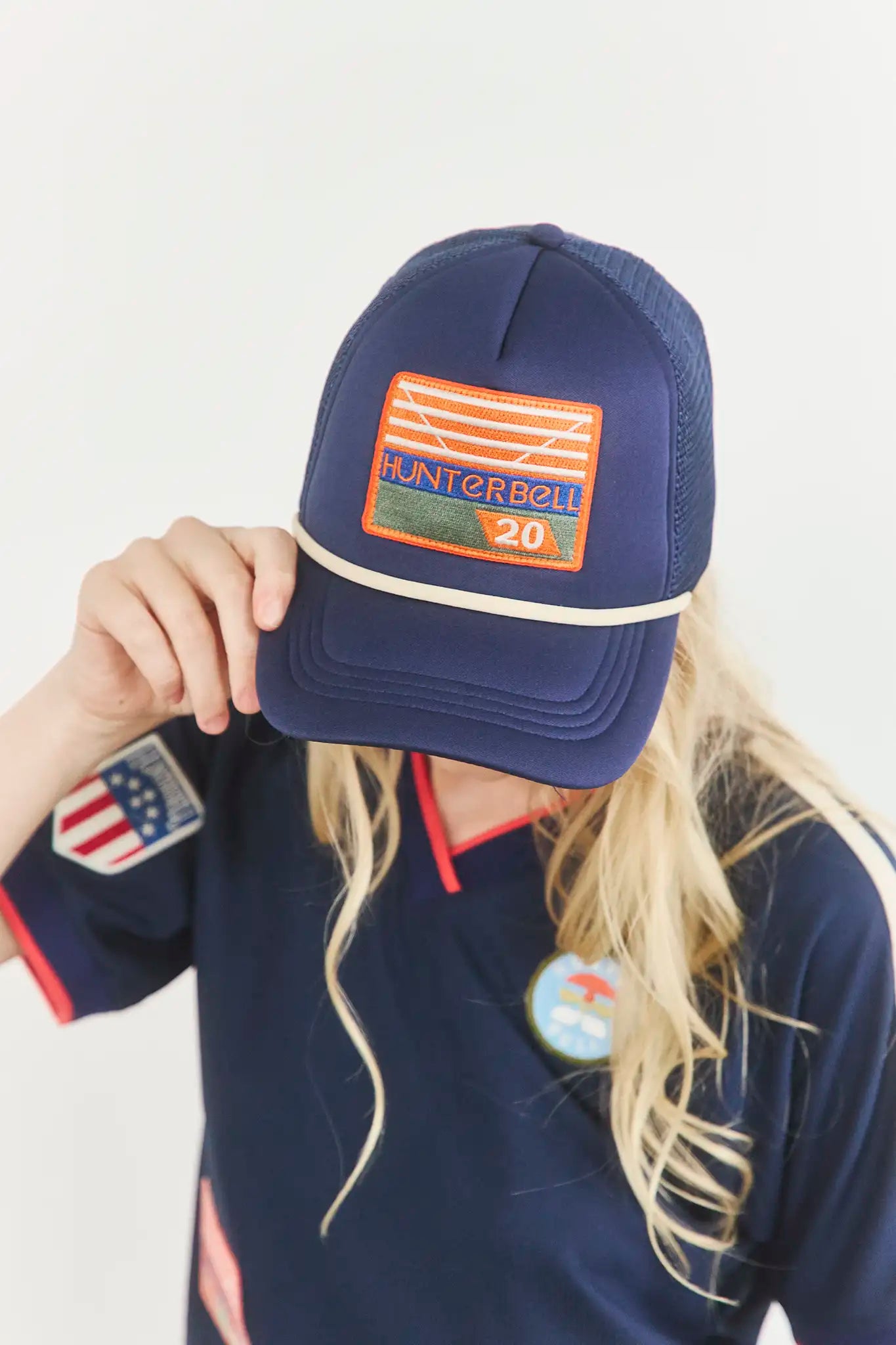 The Hunter Bell x Freya Trucker Hat in Navy paired with navy soccer jersey.