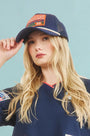 The Hunter Bell x Freya Trucker Hat in Navy paired with navy soccer jersey.