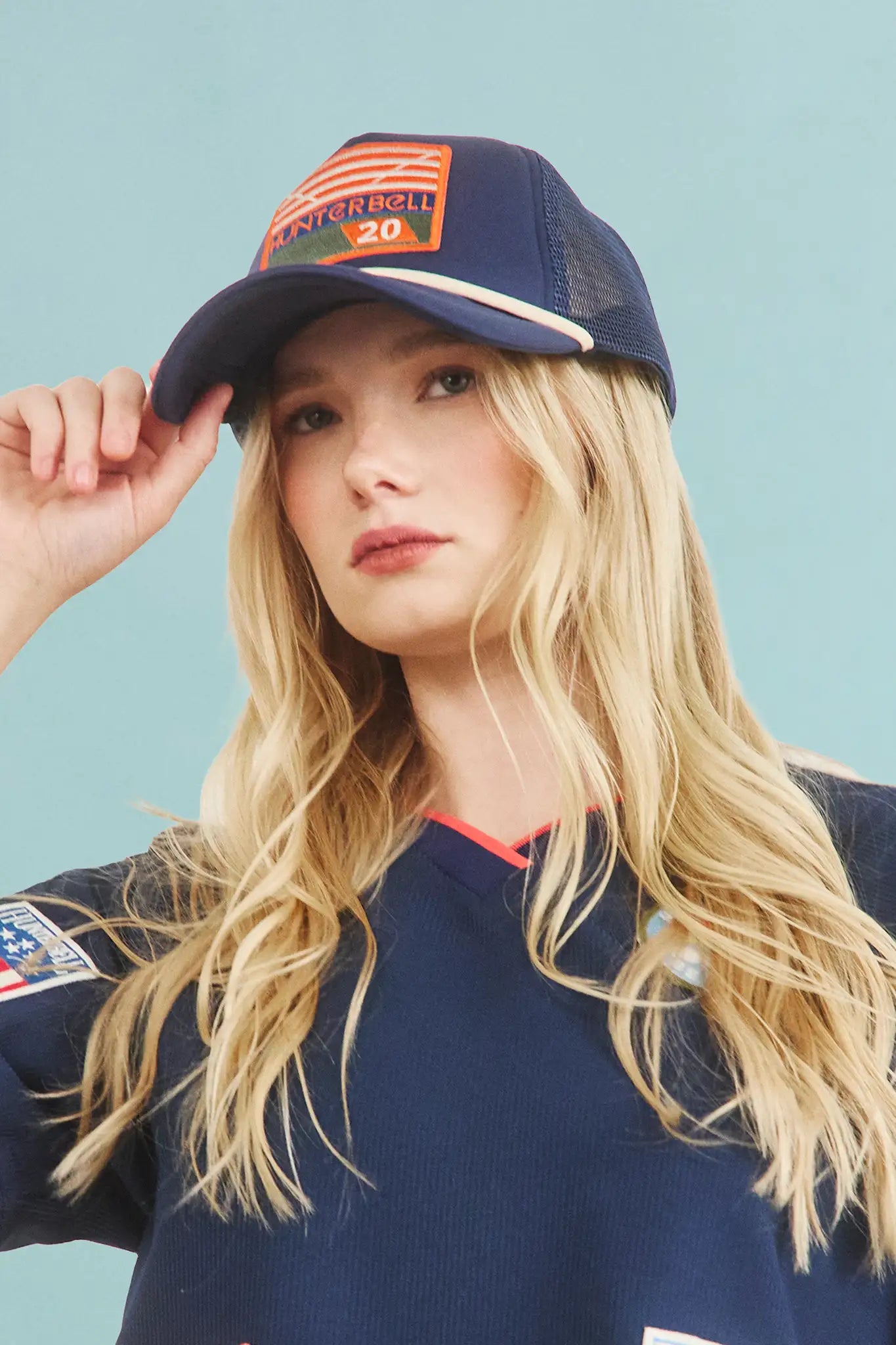 The Hunter Bell x Freya Trucker Hat in Navy paired with navy soccer jersey.