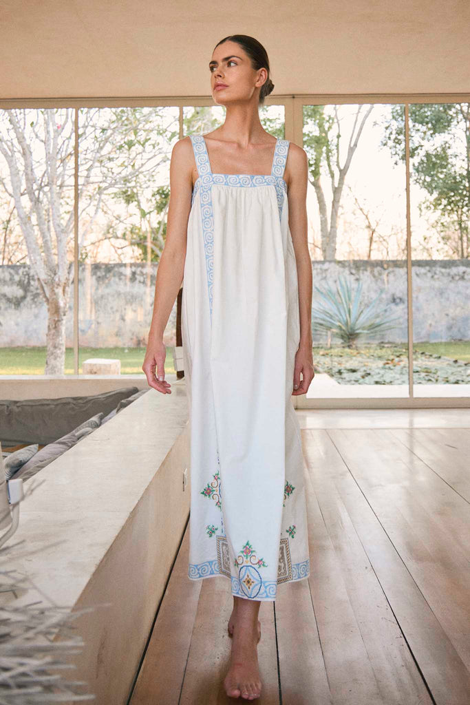 The Sailor dress features apron-style straps and intricate embroidery with a relaxed fit.