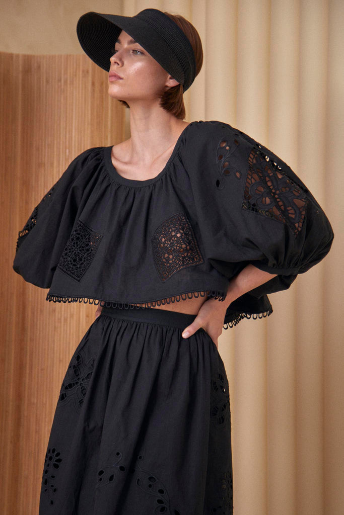 The Daisy blouse has a cropped profile, raglan sleeves, bobble trim and eyelet embroidery.