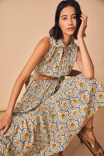 The Westin dress has a smocked waist, a peter pan collar with lace trim, and a self-tie sash.