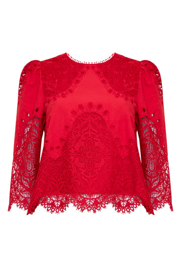 The Harriet Top has a round neck, a scalloped edge hem with bobble trim, and eyelet lace embroidery.