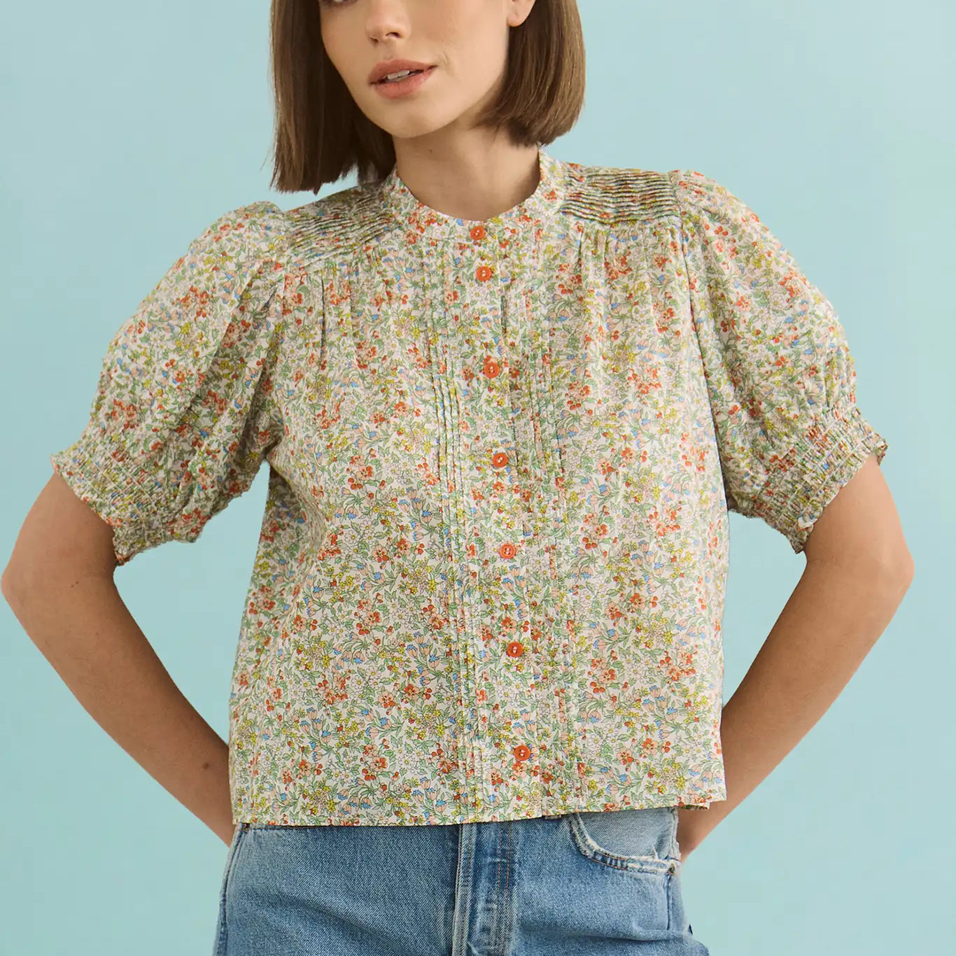The Hartley Top in Coral Multi, puff sleeve blouse with coral buttons.