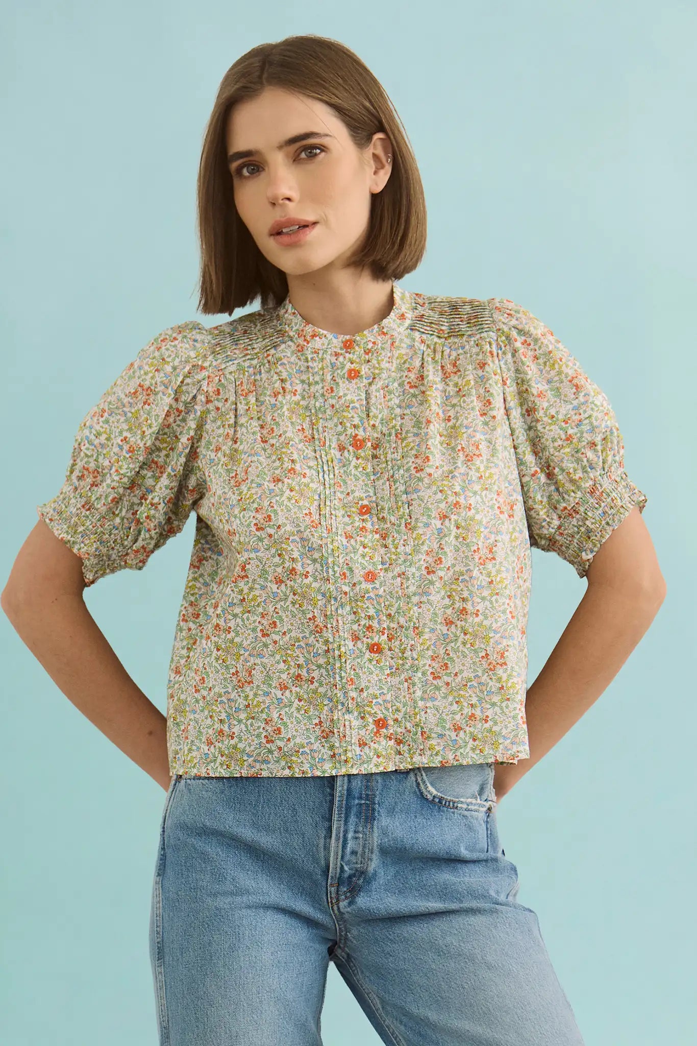 The Hartley Top in Coral Multi, puff sleeve blouse with coral buttons.