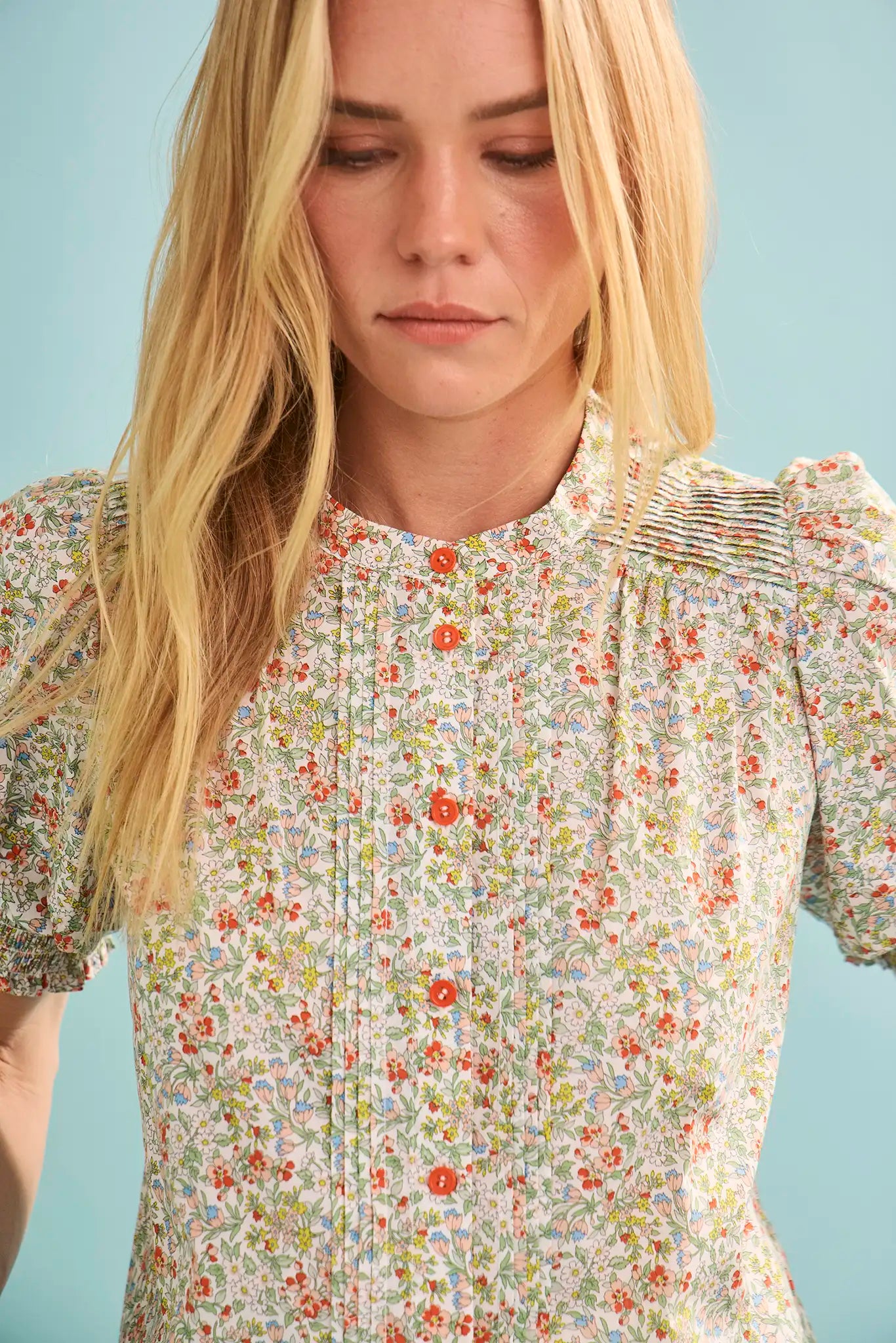 The Hartley Top in Coral Multi, puff sleeve blouse with coral buttons.