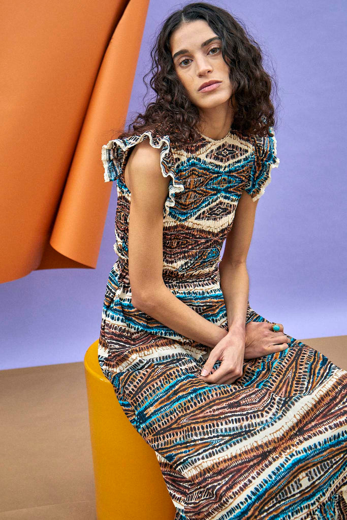 The Hayward dress has a fitted bodice and lace trim at the neckline and hem of the flutter sleeves.