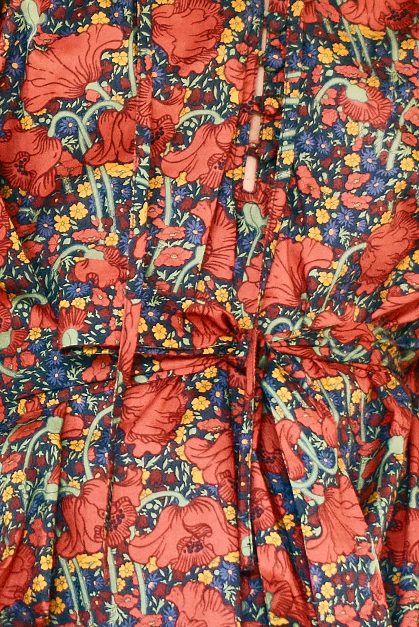 The Holloway Dress has v-neck, elbow-length puff sleeves, tiered ruffled seams and an optional sash.