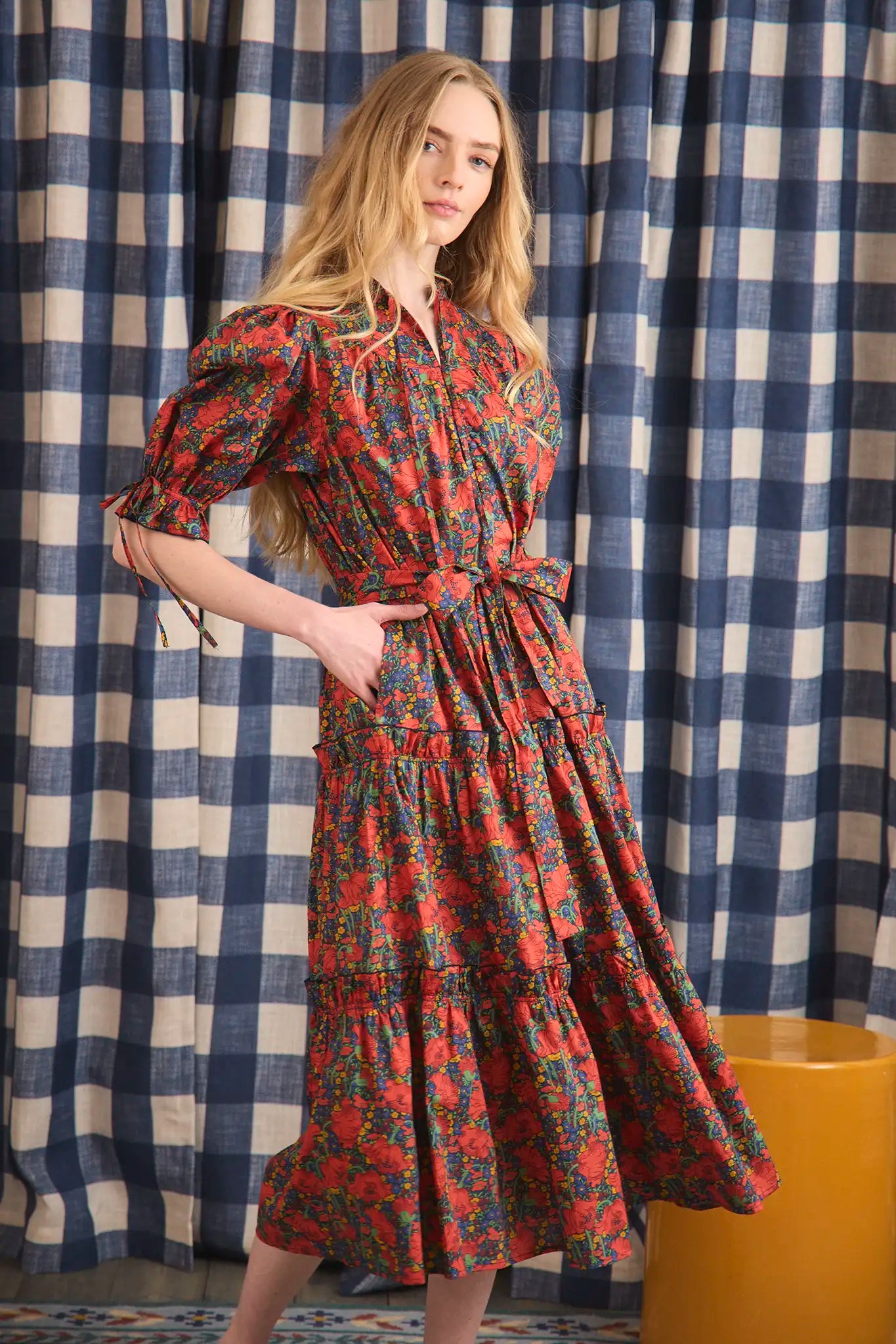 The Holloway Dress has v-neck, elbow-length puff sleeves, tiered ruffled seams and an optional sash.